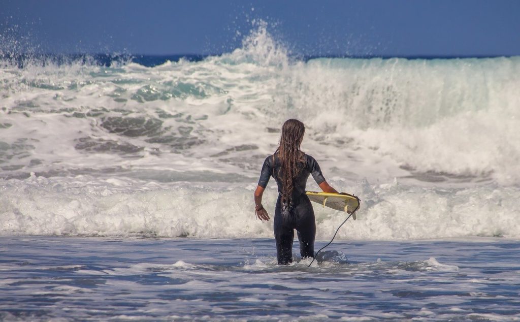 surfer-is-standing-in-shallow